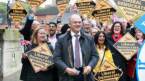 Ed Davey in front of crowd with Lib Dem diamond signs